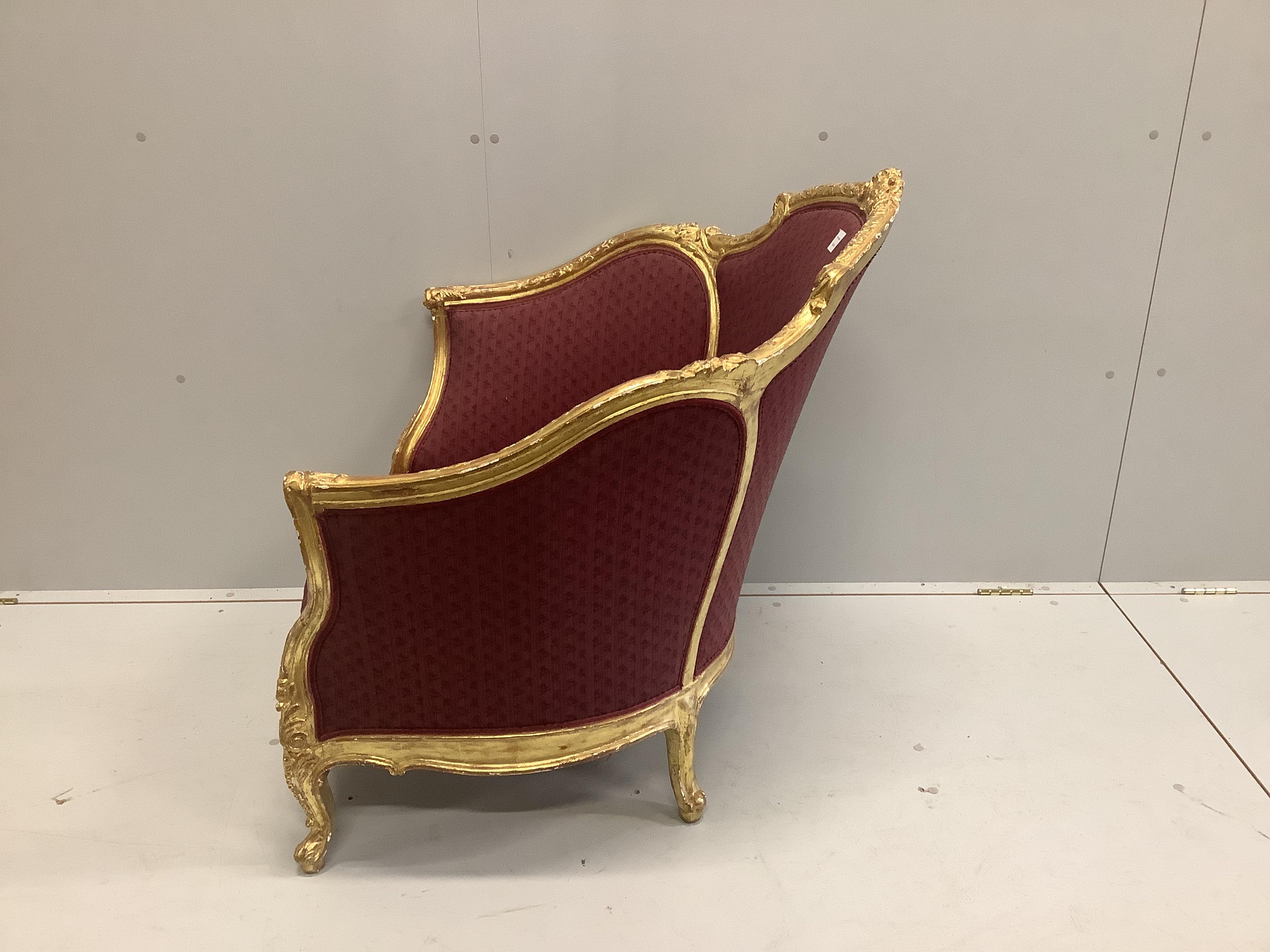 A Louis XVI style carved giltwood tub framed salon chair, width 90cm, depth 70cm, height 90cm